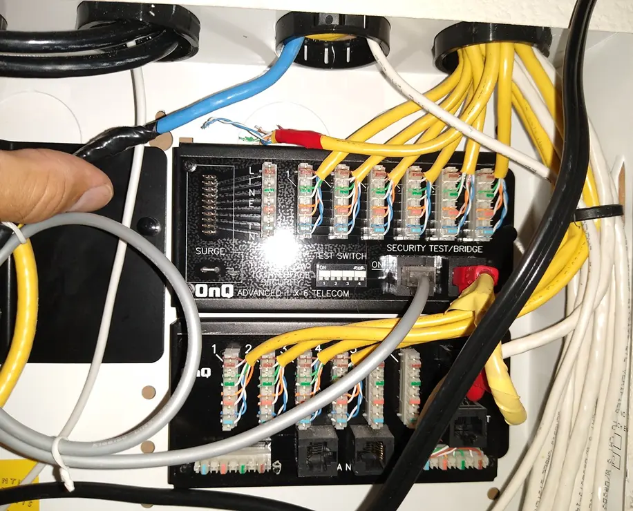 A close-up image of a networking setup showing cables and connectors in a junction box.