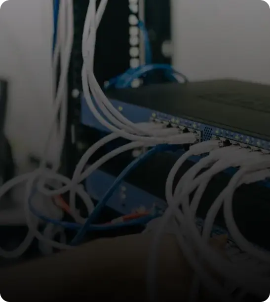 A close-up image of a network switch with multiple Ethernet cables connected.