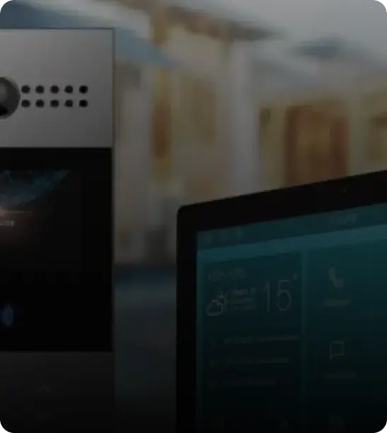 A close-up of a modern intercom device next to a digital display or screen.