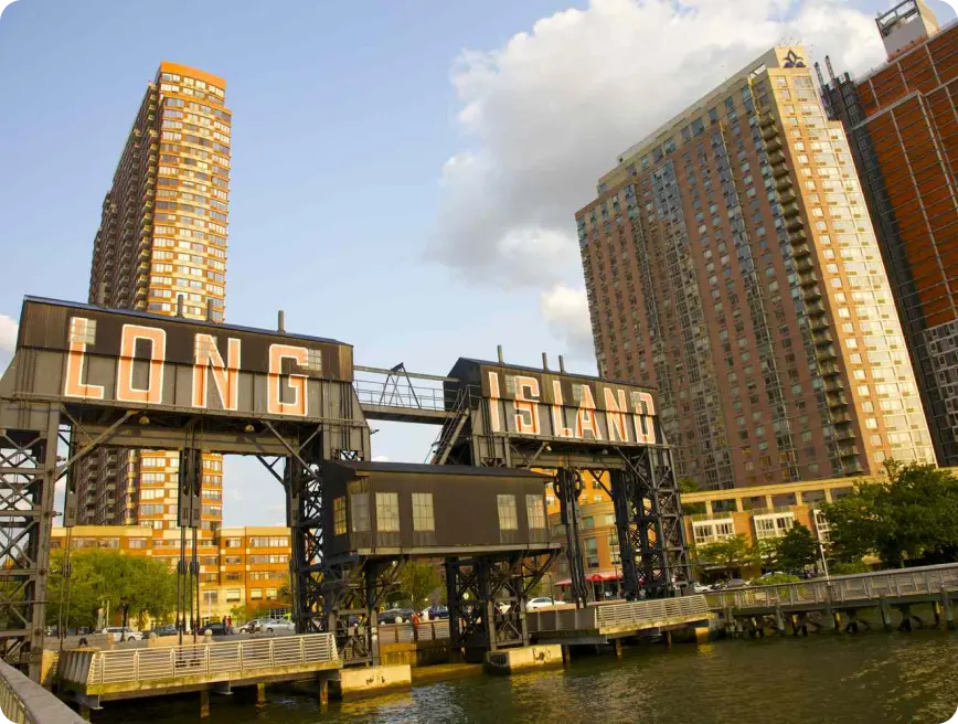 A structure with the words "LONG ISLAND" on it, surrounded by buildings and water.