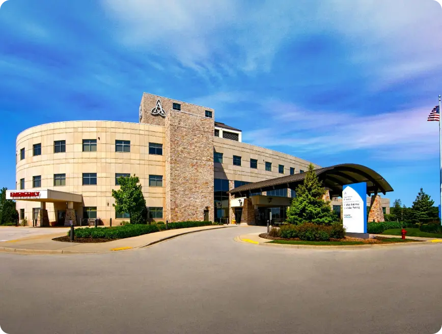 A modern medical facility with a curved stone facade