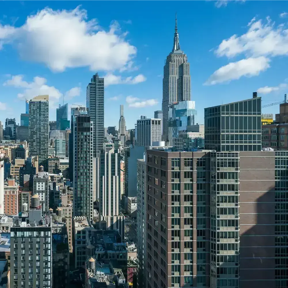 A panoramic view of a city skyline featuring various high-rise buildings