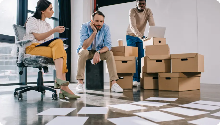 A group of three people in a modern office setting,