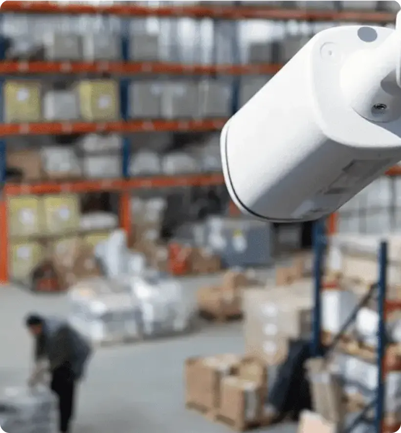 A security camera is in focus in the foreground