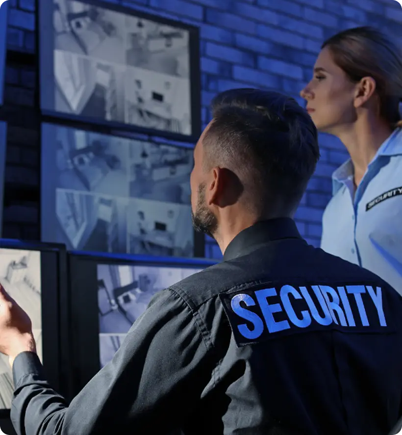 A security team monitoring surveillance feeds in a dark room.